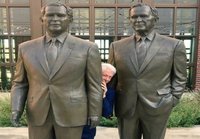 Clinton hiding behind the bushes