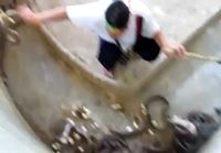 Man with Balls of Steel Cleaning Up the Cobra Habitat at a Zoo