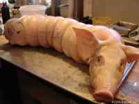 Porchetta - A whole, stuffed, roasted pig. After being de-boned, the meat is seasoned with garlic, black pepper, salt and rosemary. Then, it is layered with pork sausage and a butterflied pork loin, before being sewn together again.